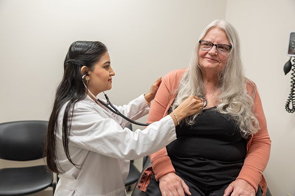 Dr. Naz checking patient's heart