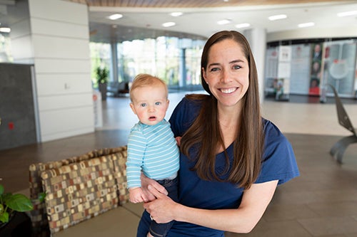 Nurse smiling with baby