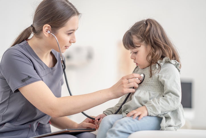 nursing in gray scrubs caring for child