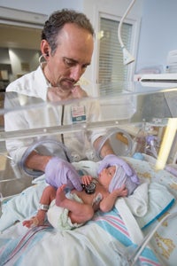 doctor monitoring baby in NICU